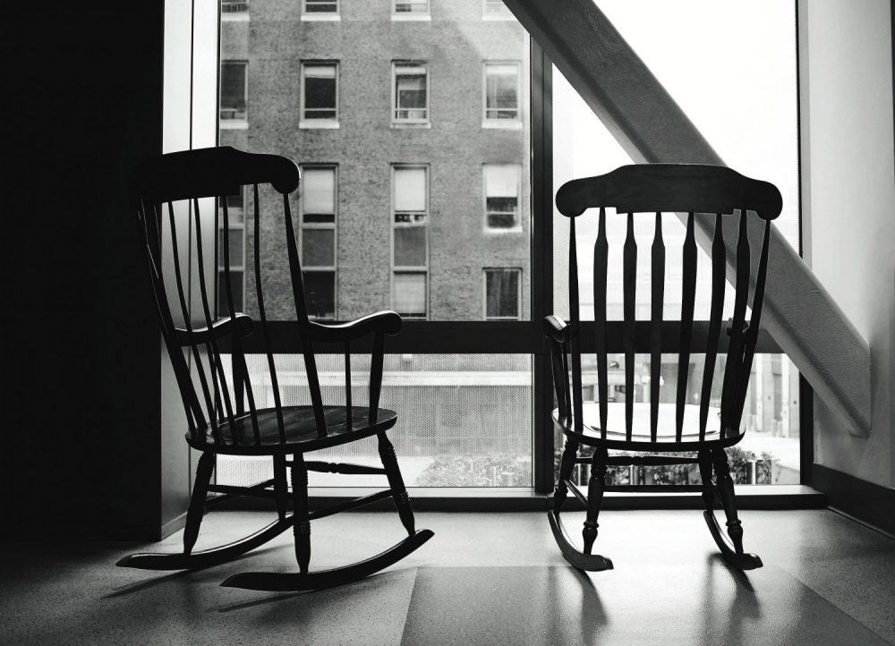 Empty Rocking Chairs By Window At Home